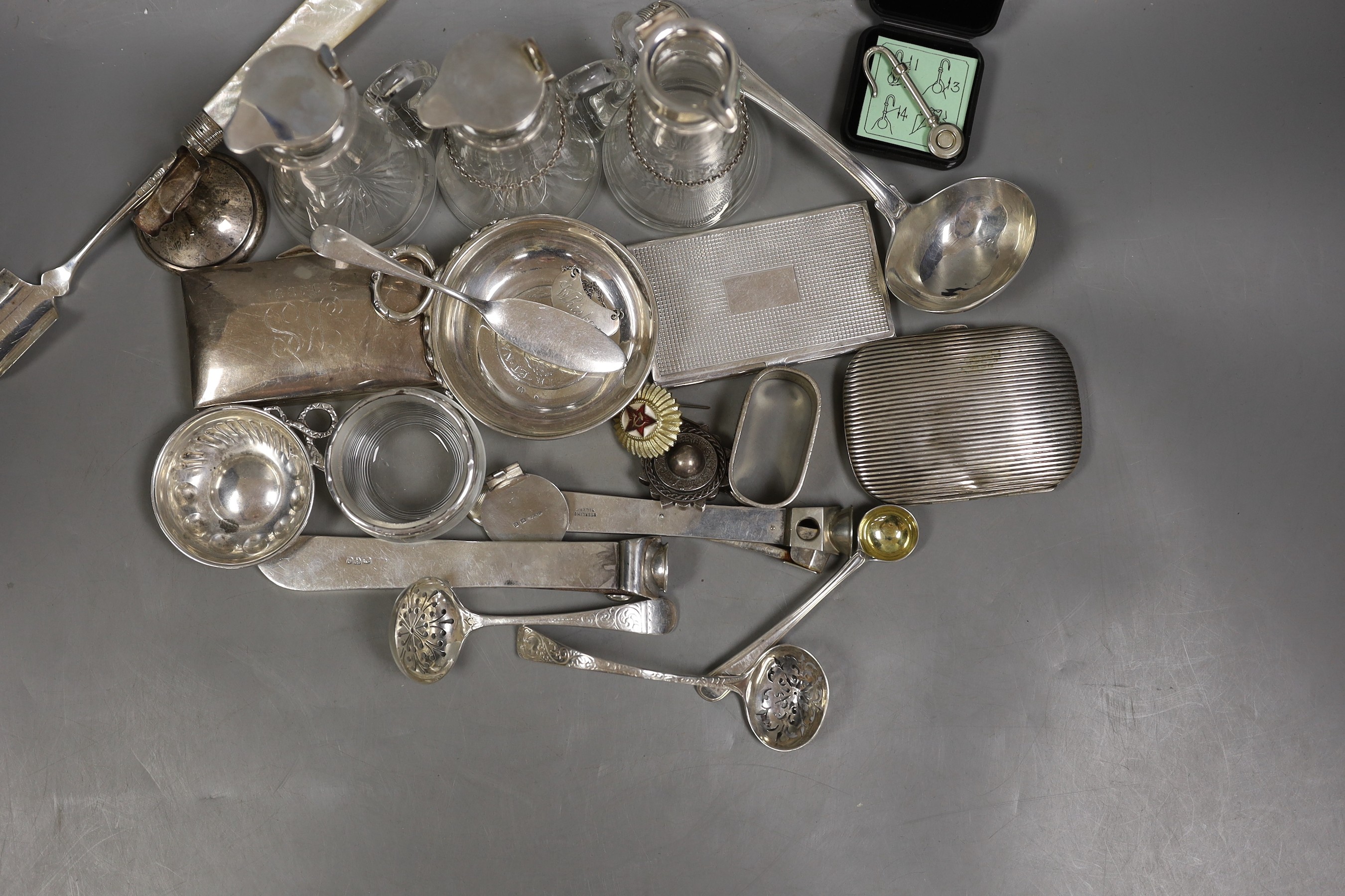 A silver mounted cigar cutter, a similar sterling mounted cutter and a collection of small silver and white metal items including three silver mounted whisky tot jugs including a pair by Asprey & Co, Birmingham, 1913, cu